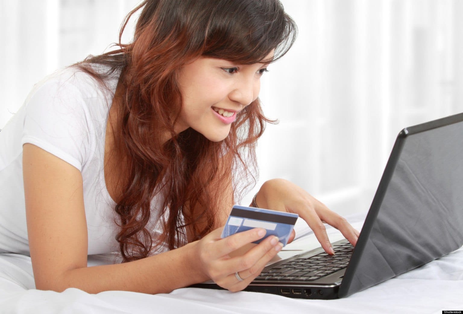 woman with credit card on laptop making purchase
