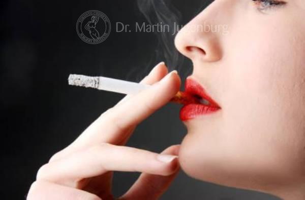 woman smoking cigarette red lipstick black background